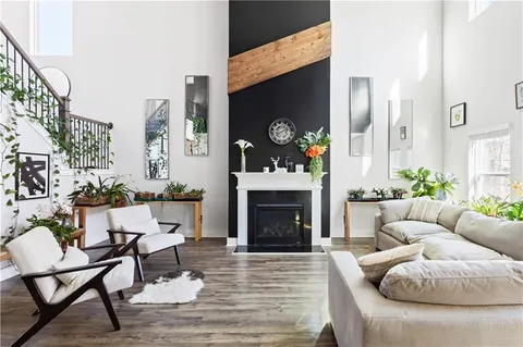 a living room with furniture a fireplace and a flat screen tv