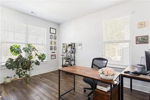 a view of a workspace with furniture and a potted plant