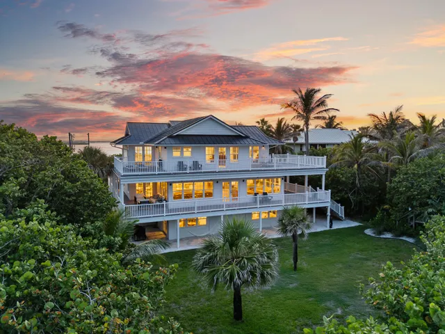 a living room with furniture a fireplace and a chandelier