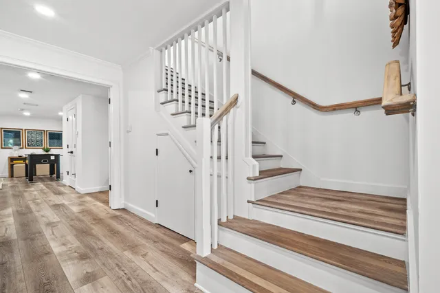 a large bedroom with a large bed and a chandelier fan