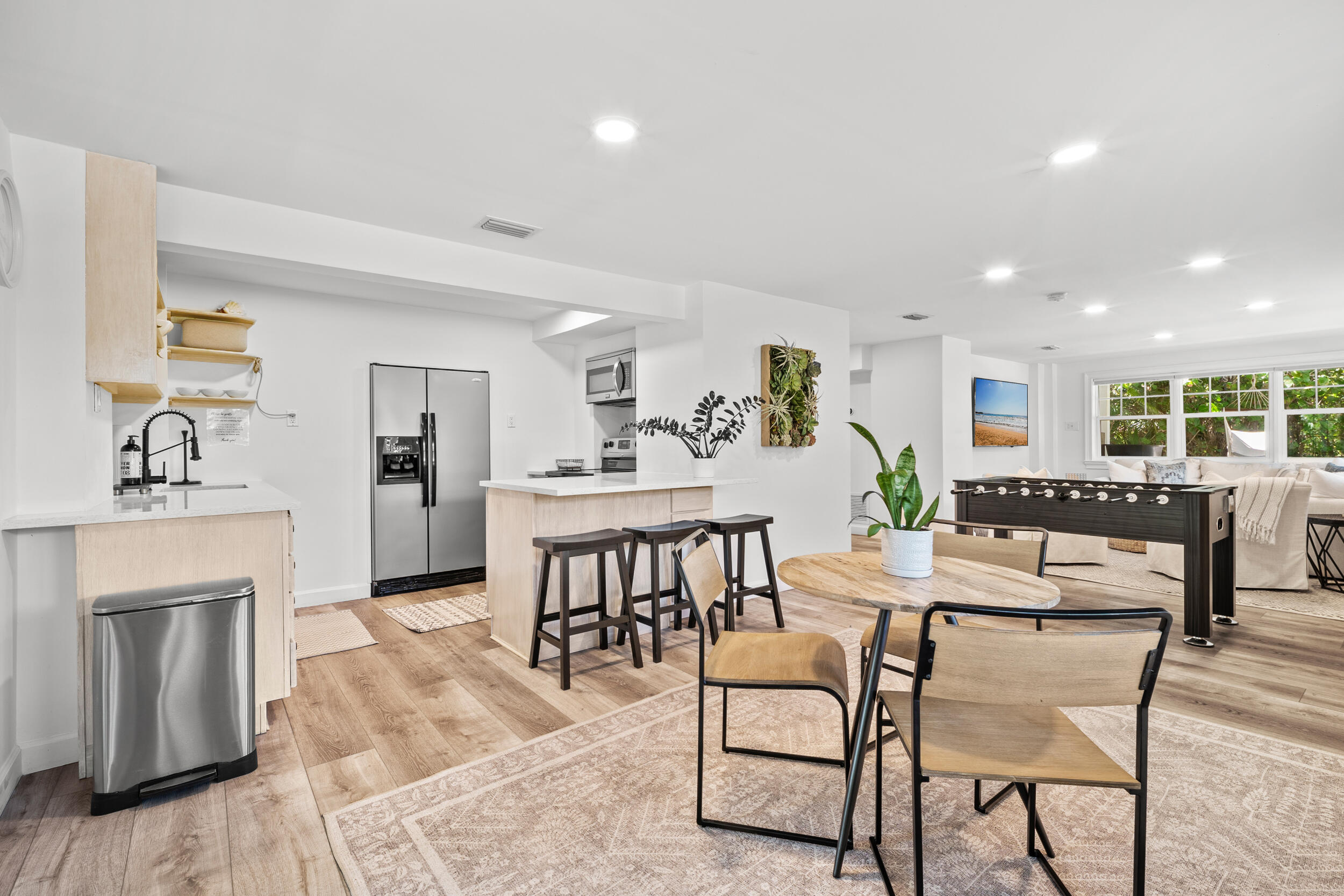 12376 Florida A1A Vero Beach, FL 32963 - Photo 39 of 92 a living room with furniture a fireplace and a dining table with wooden floor
