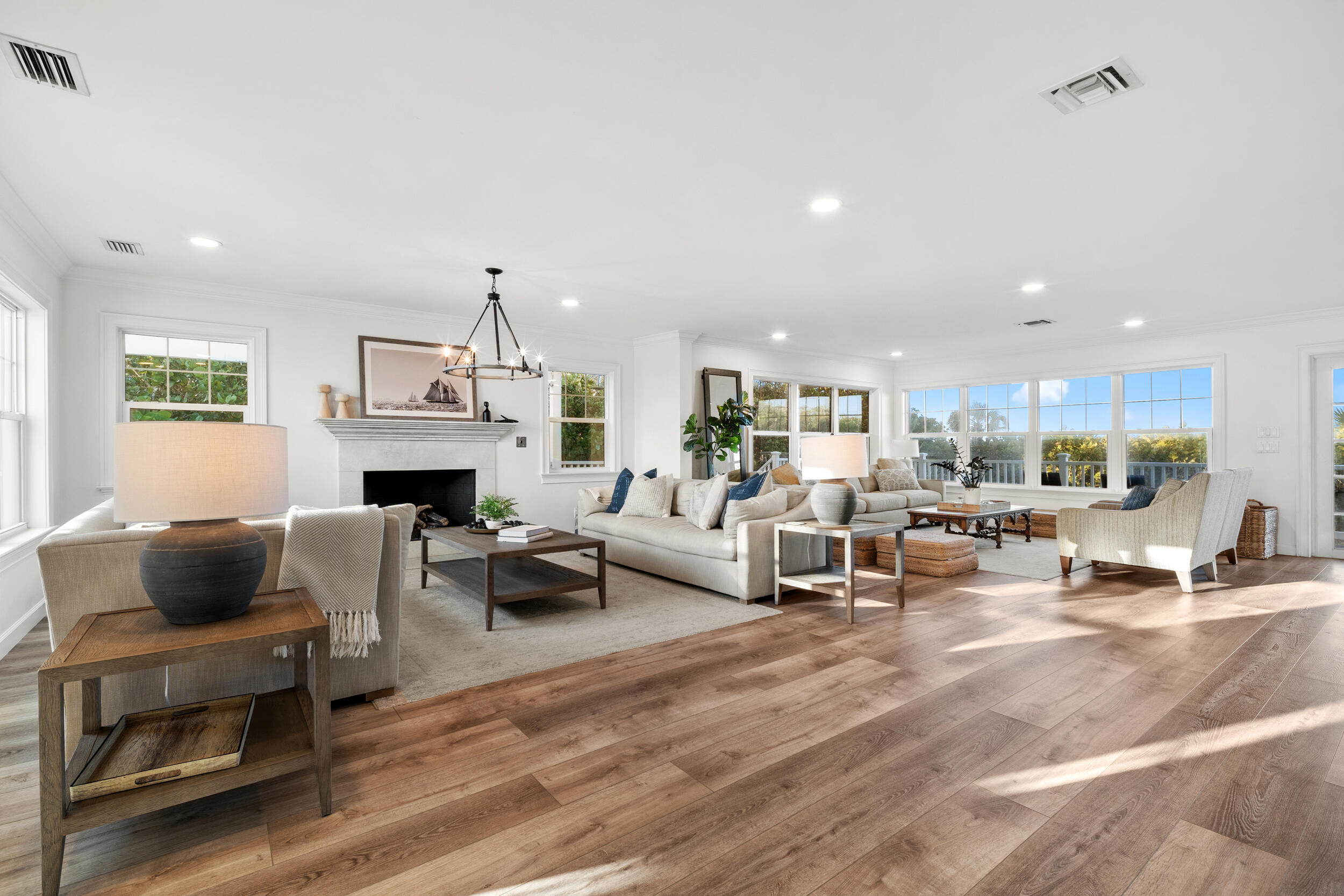 12376 Florida A1A Vero Beach, FL 32963 - Photo 52 of 92 a living room with furniture a fireplace and a chandelier