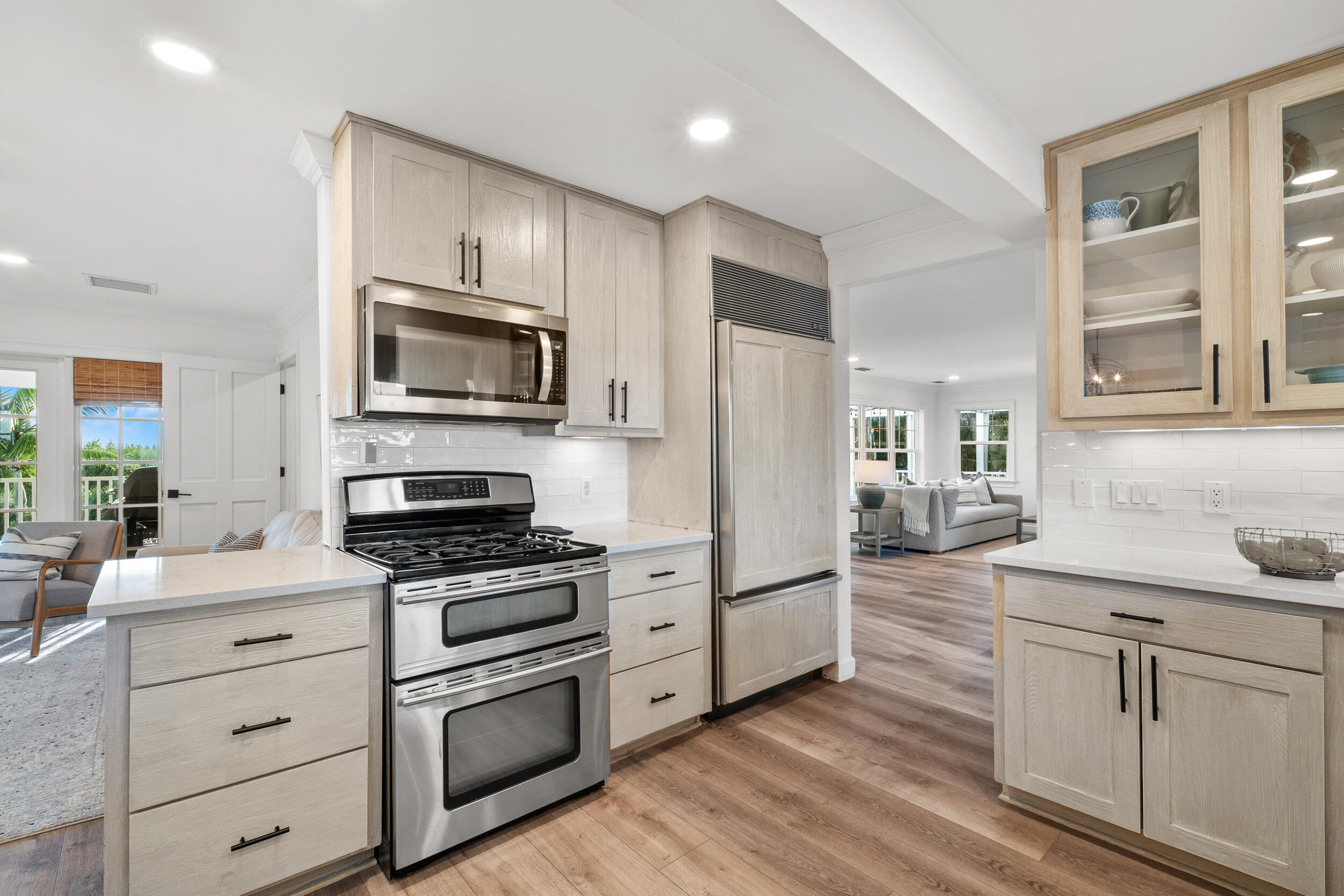 12376 Florida A1A Vero Beach, FL 32963 - Photo 60 of 92 a kitchen with granite countertop cabinets stainless steel appliances and wooden floor