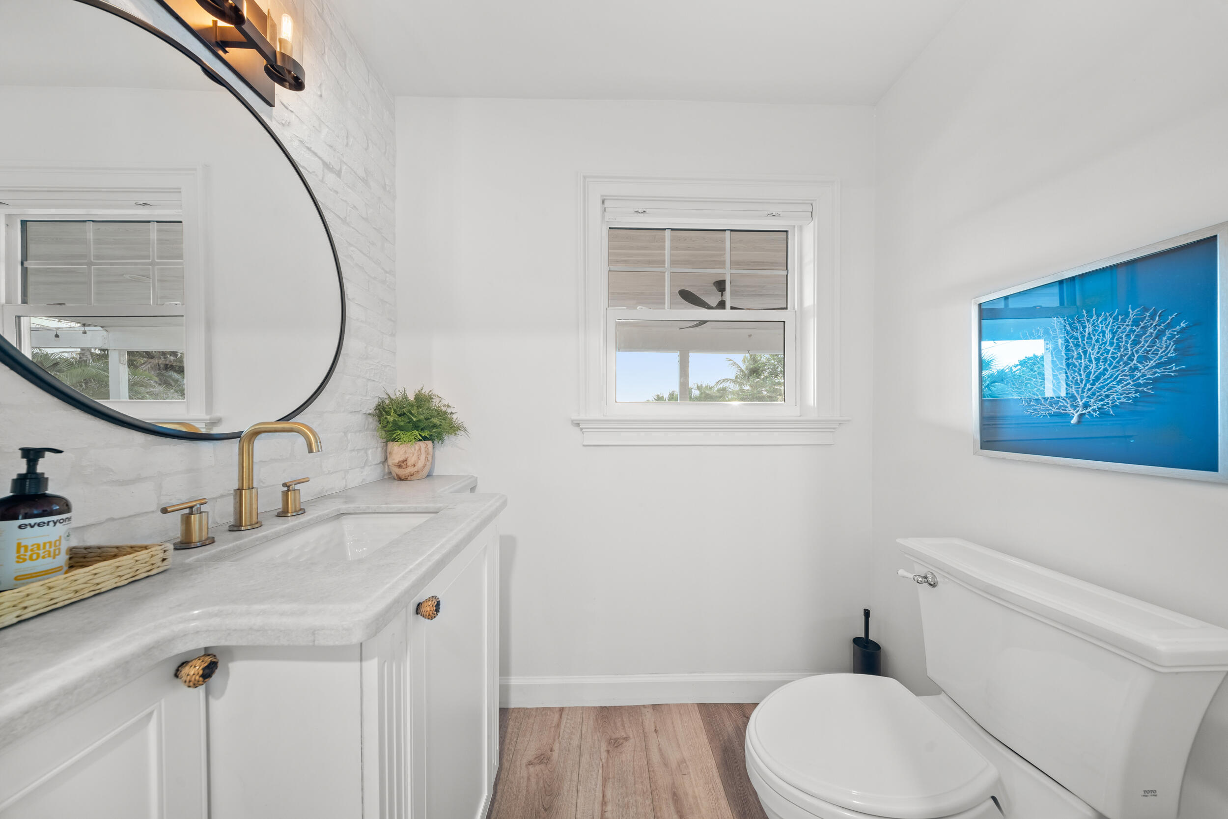 12376 Florida A1A Vero Beach, FL 32963 - Photo 64 of 92 a bathroom with a sink a toilet and a mirror