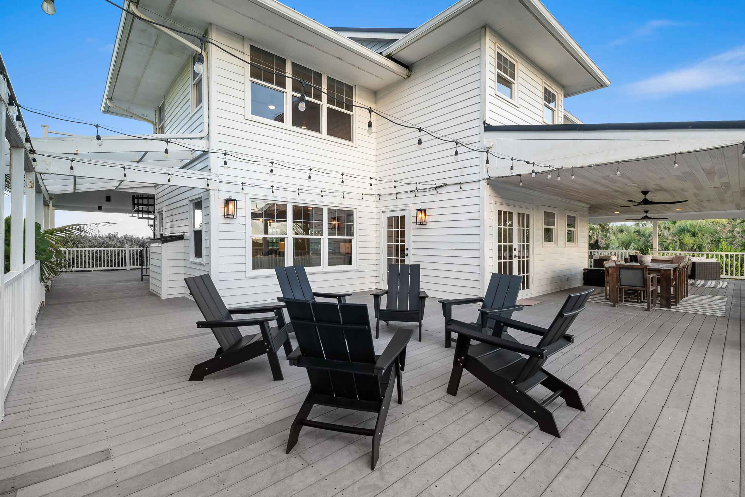 12376 Florida A1A Vero Beach, FL 32963 - Photo 69 of 92 a view of a patio with table and chairs with wooden floor