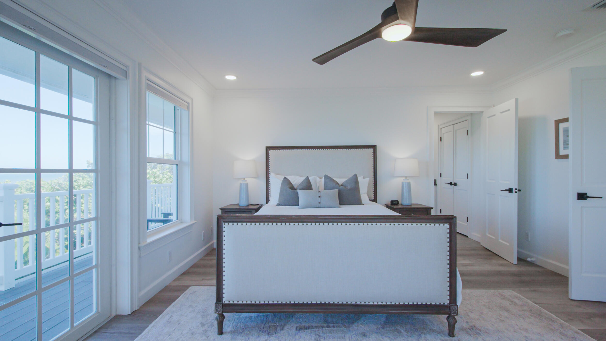 12376 Florida A1A Vero Beach, FL 32963 - Photo 86 of 92 a large bedroom with a large bed and a chandelier fan