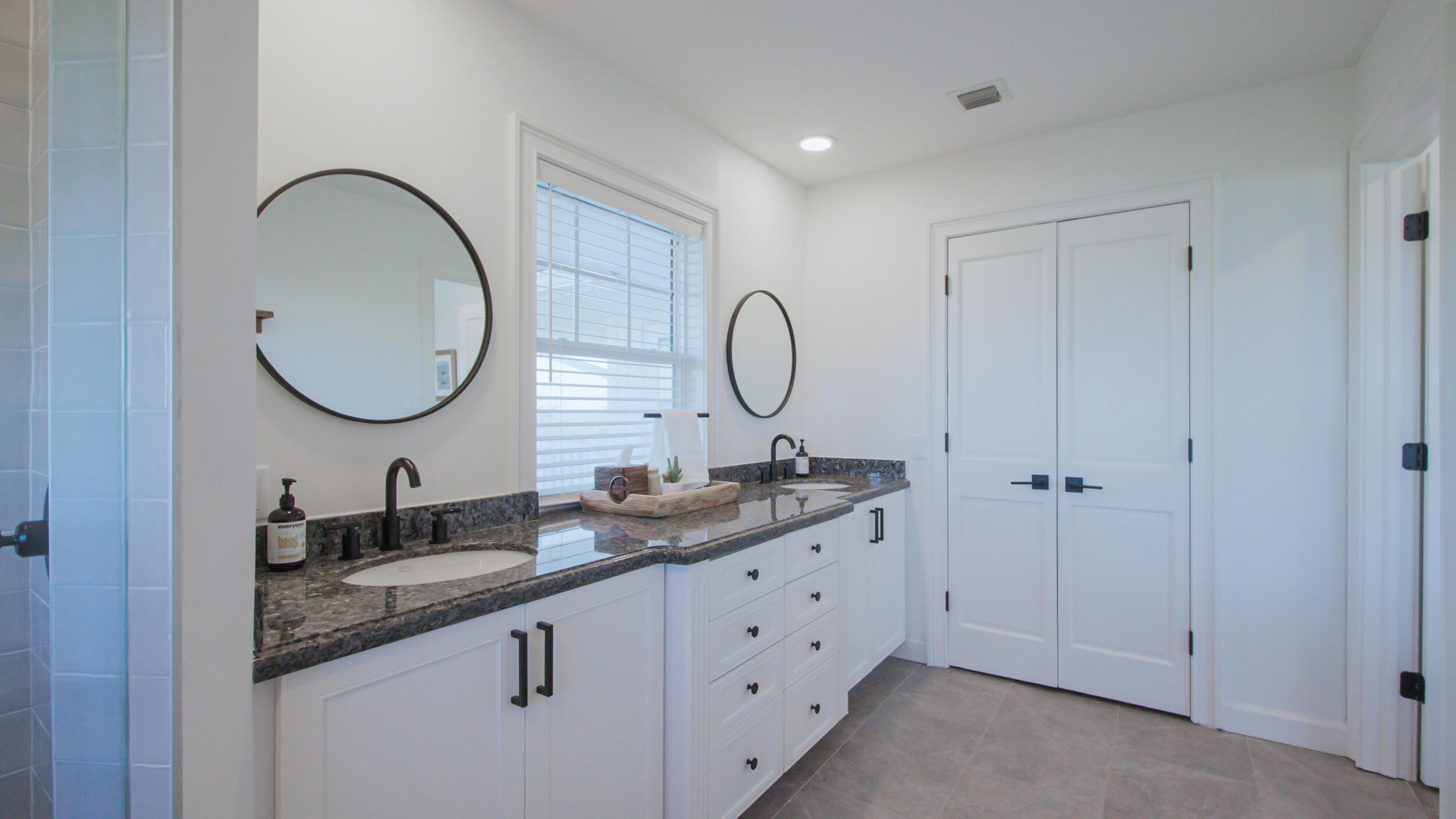12376 Florida A1A Vero Beach, FL 32963 - Photo 88 of 92 a bathroom with a granite countertop double vanity sink and a mirror