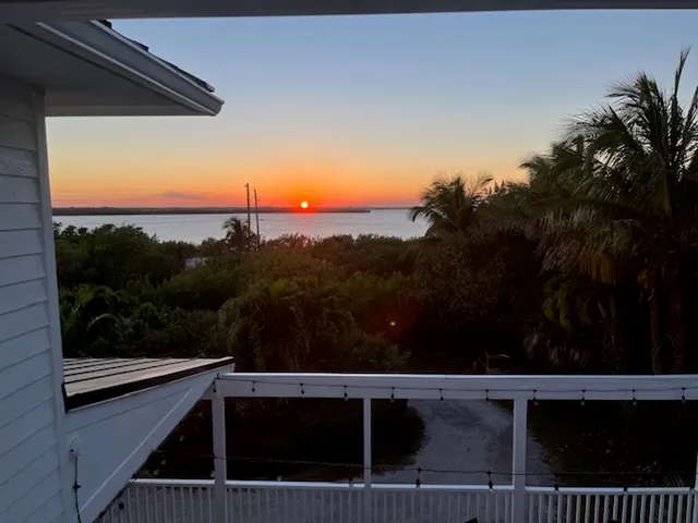 a view of an house with backyard and sitting area