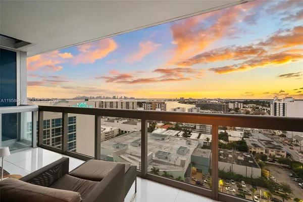 a view of roof deck with furniture and city view
