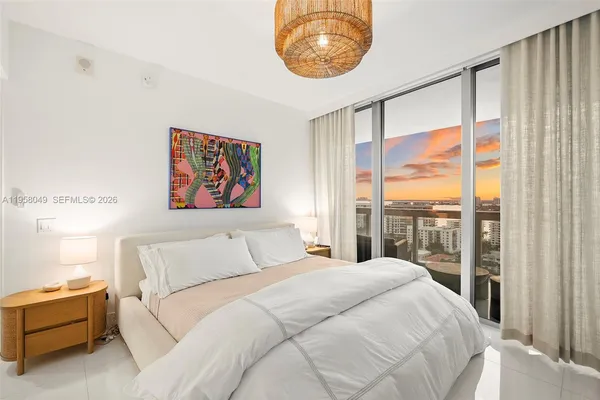 a bedroom with a large bed and a window