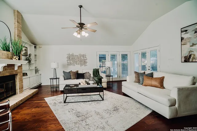 a living room with furniture a rug and a chandelier