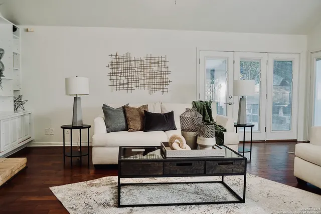 a living room with furniture and a lamp