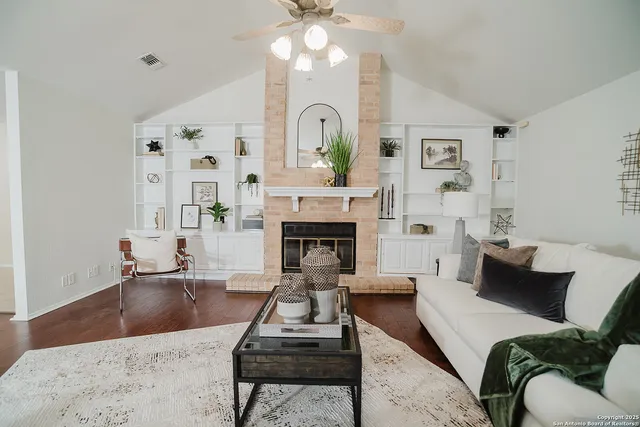 a living room with furniture and a fireplace