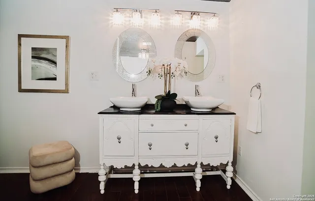 a room with a table chairs and a chandelier