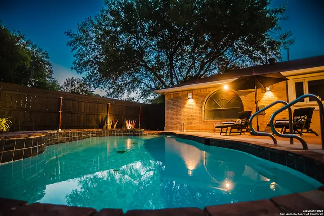 a view of a swimming pool with a yard