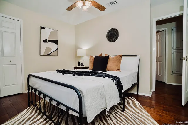 a bedroom with bed and a chandelier