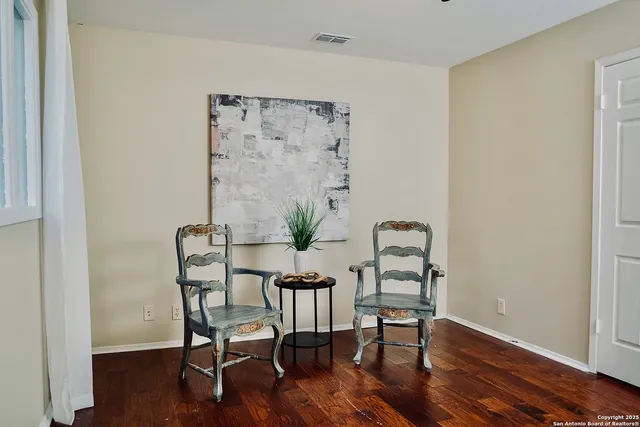a dining room with furniture and wooden floor