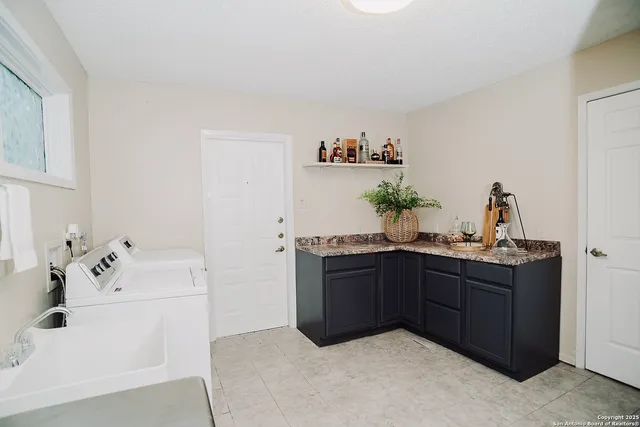 a kitchen with stainless steel appliances granite countertop a sink and cabinets