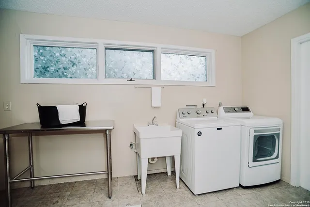 a view of cabinets a washer and dryer