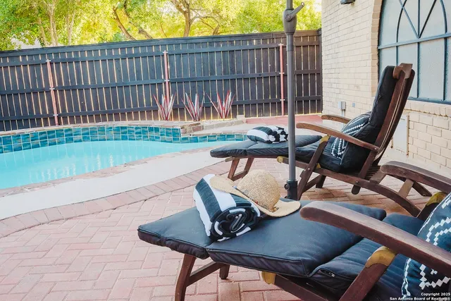a view of a chair and tables in the patio