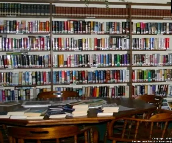 a living room with lots of furniture and a book shelf
