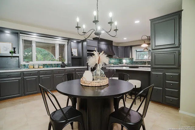 a kitchen with a dining table and chairs