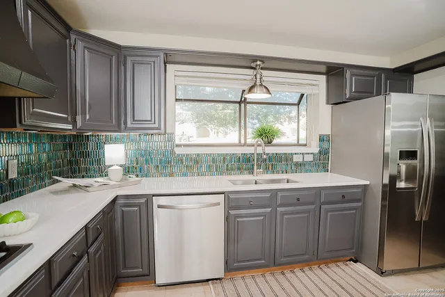 a kitchen with a sink stove and refrigerator