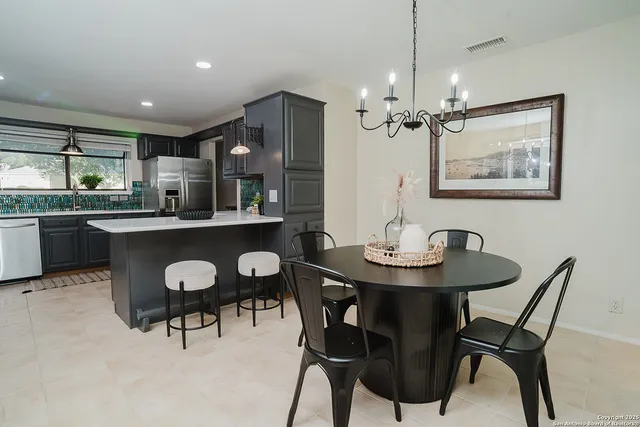a dining room with furniture and window