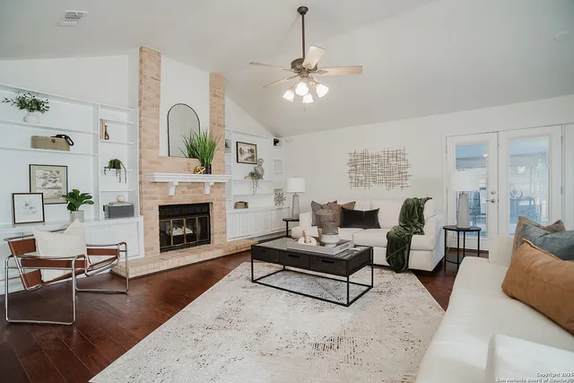 a living room with furniture and a fireplace