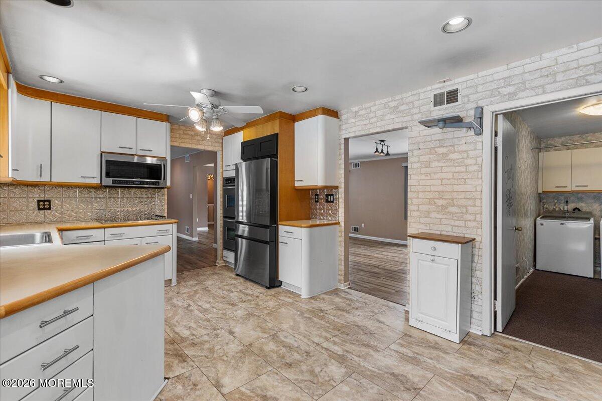 323 Arlene Terrace Aberdeen, NJ 07747 - Photo 11 of 28 a kitchen with a refrigerator and a sink