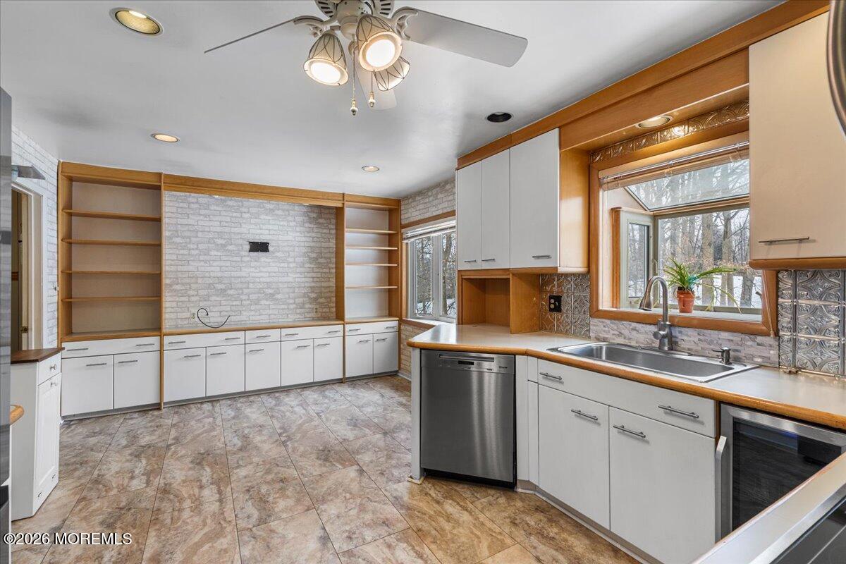 323 Arlene Terrace Aberdeen, NJ 07747 - Photo 12 of 28 a large white kitchen with a sink and dishwasher a stove top oven with wooden floor