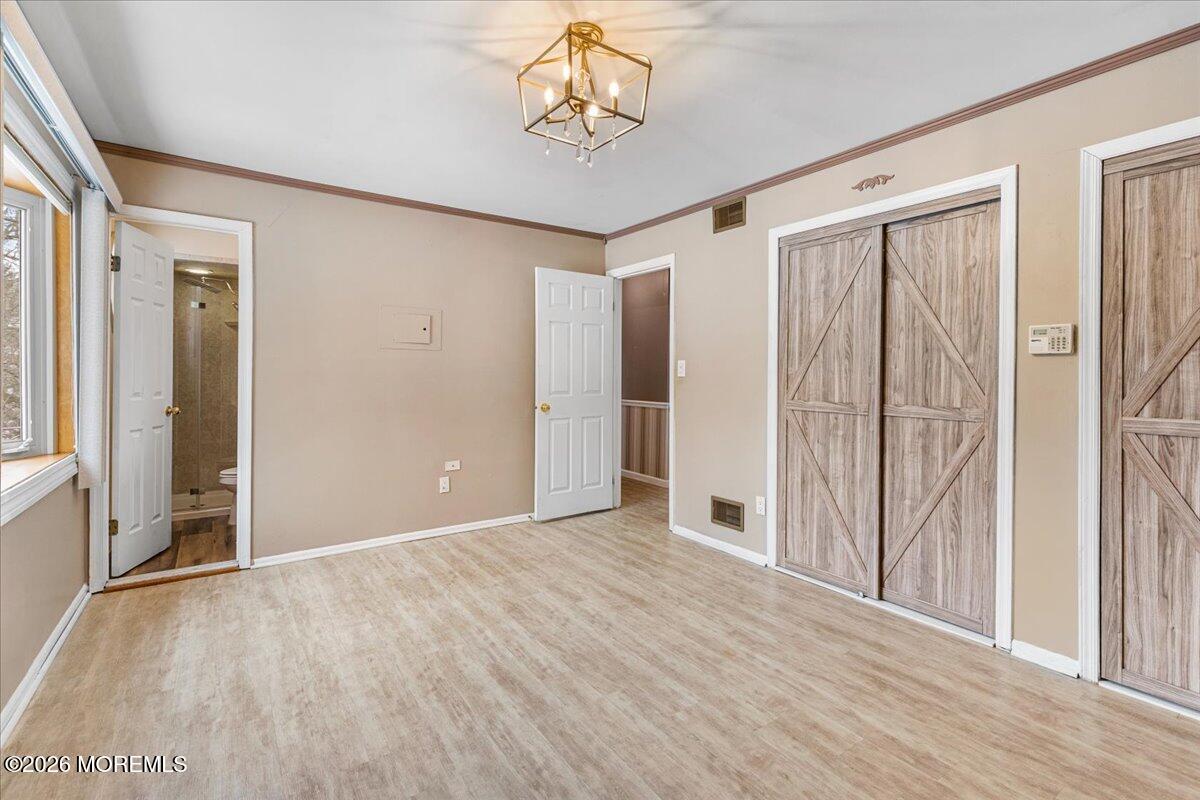 323 Arlene Terrace Aberdeen, NJ 07747 - Photo 16 of 28 wooden floor in an empty room with a window