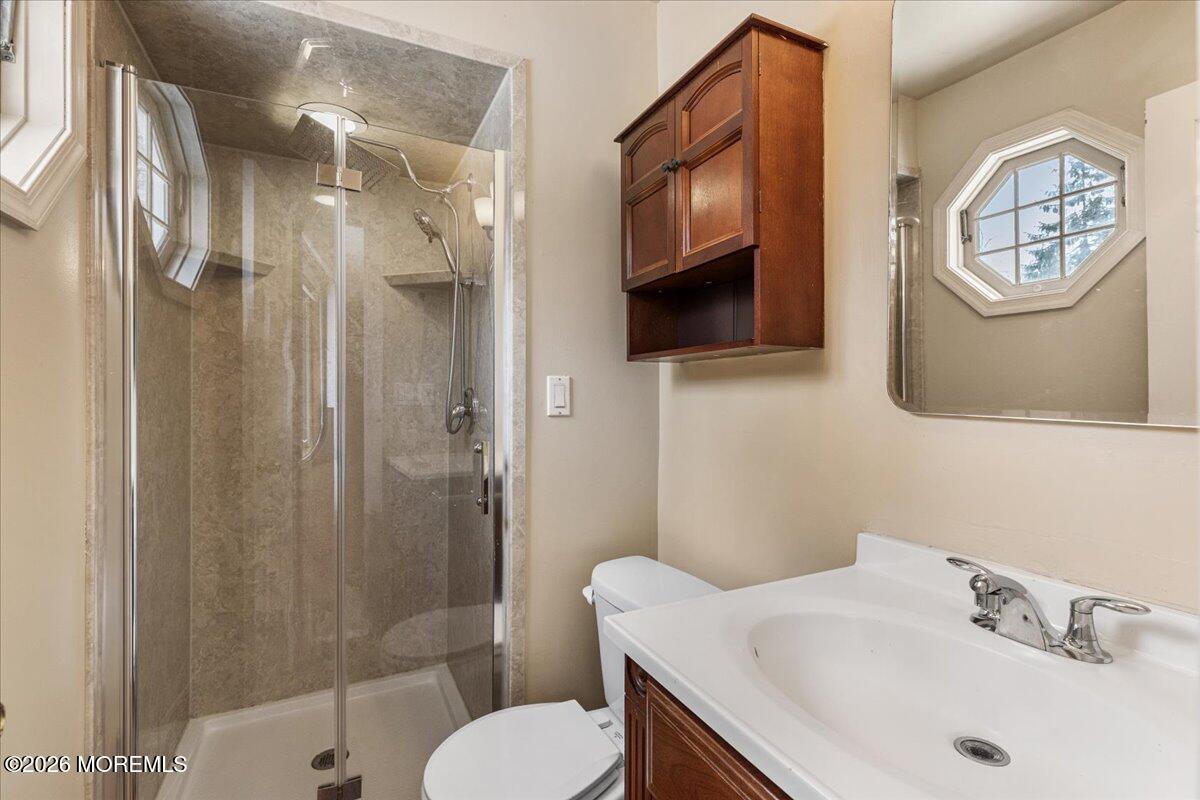 323 Arlene Terrace Aberdeen, NJ 07747 - Photo 17 of 28 a bathroom with a sink toilet and shower