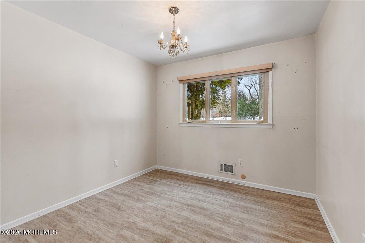 323 Arlene Terrace Aberdeen, NJ 07747 - Photo 18 of 28 wooden floor in an empty room with a window