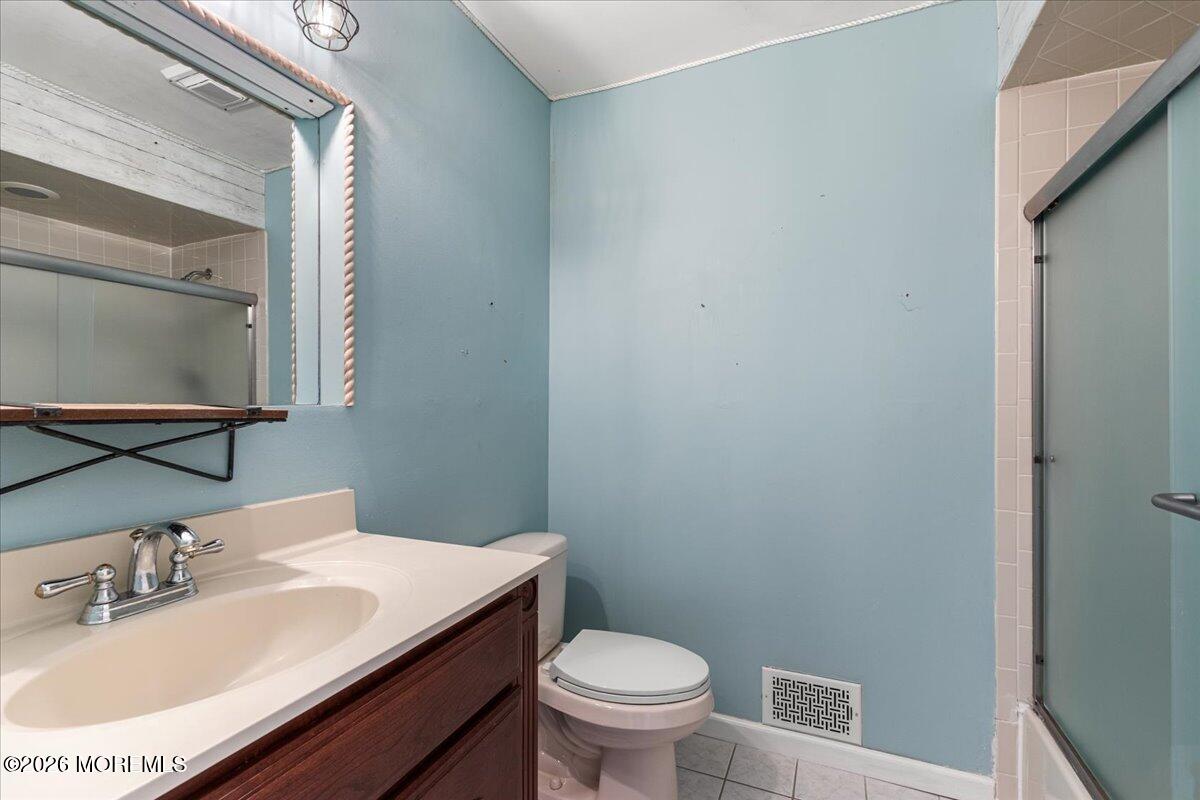 323 Arlene Terrace Aberdeen, NJ 07747 - Photo 20 of 28 a bathroom with a sink toilet and a mirror