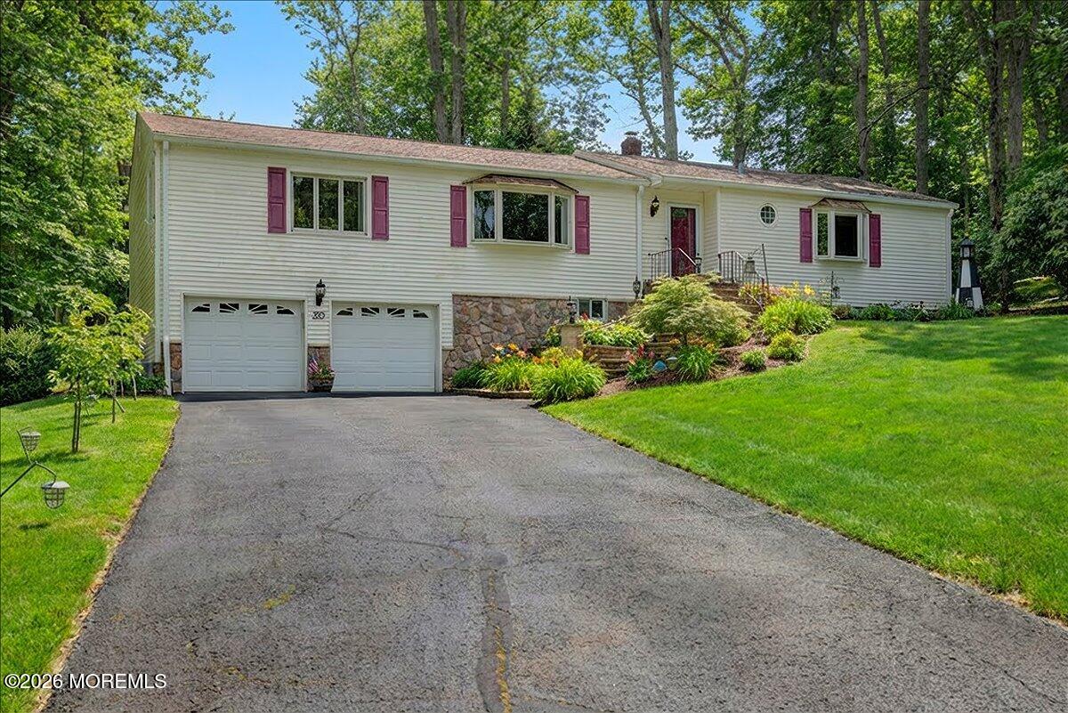 323 Arlene Terrace Aberdeen, NJ 07747 - Photo 2 of 28 a front view of house with a garden