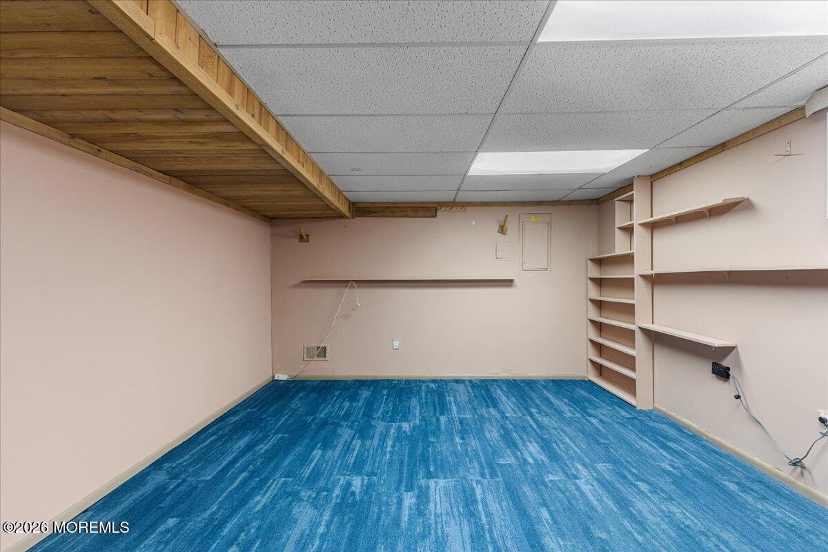 323 Arlene Terrace Aberdeen, NJ 07747 - Photo 23 of 28 a view of empty room with wooden floor and cabinet
