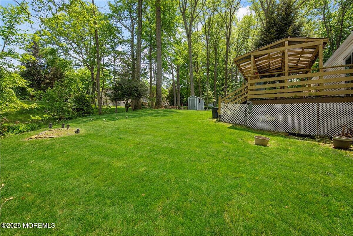 323 Arlene Terrace Aberdeen, NJ 07747 - Photo 26 of 28 a view of a backyard with a garden and entertaining space