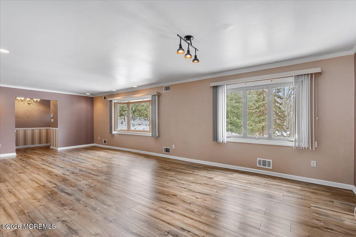 323 Arlene Terrace Aberdeen, NJ 07747 - Photo 8 of 28 a view of an empty room with wooden floor and a window