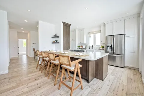 a bathroom with a granite countertop sink mirror and window