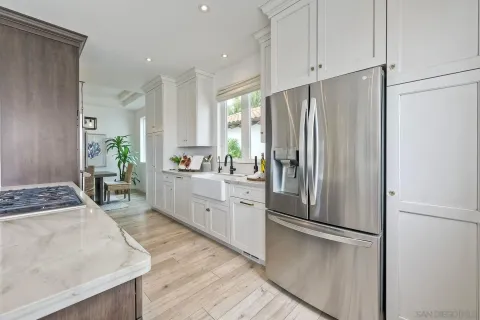 a kitchen with a stove a sink and a refrigerator