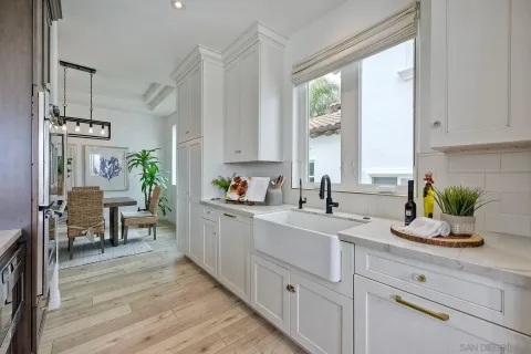 a spacious bathroom with a granite countertop sink toilet and shower curtains