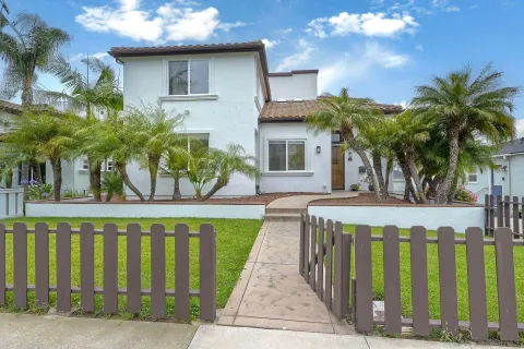 a front view of a house with a garden