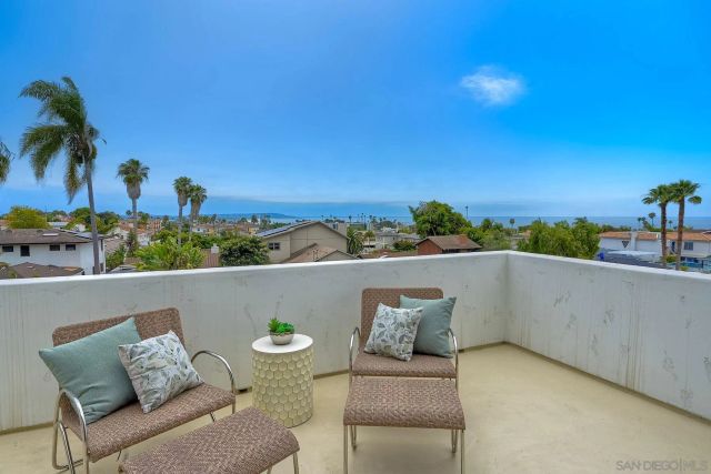 a view of a room with a ceiling fan and a window