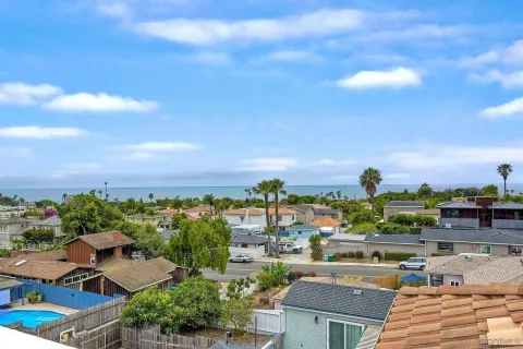 an empty room with closet and windows