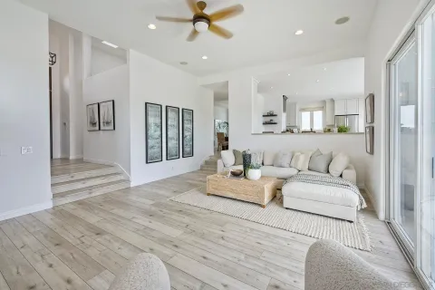 a spacious bedroom with a bed and ceiling fan