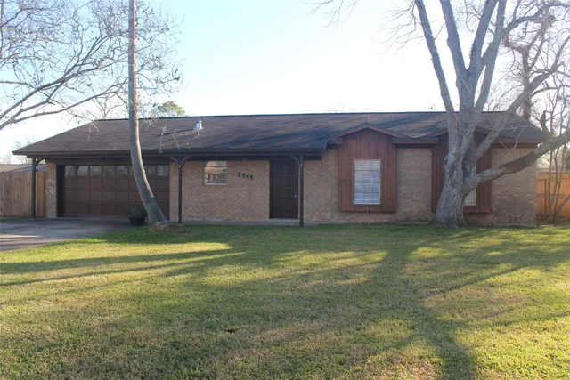 a view of a house with a yard and garage