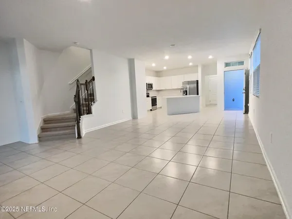 a kitchen with kitchen island granite countertop a stove a sink and a microwave