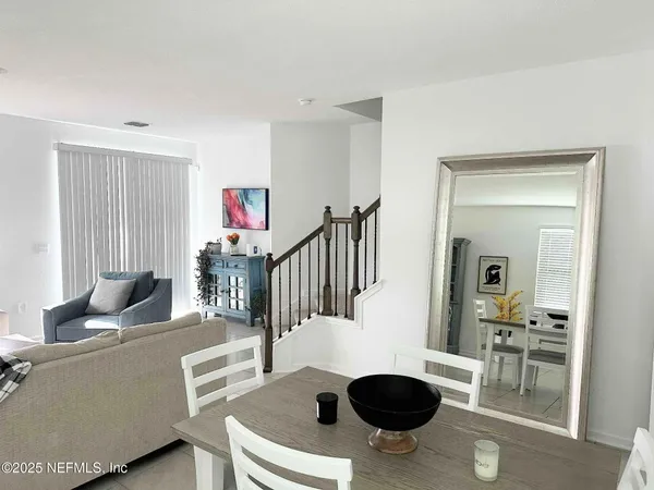 a living room with furniture a window and a flat screen tv