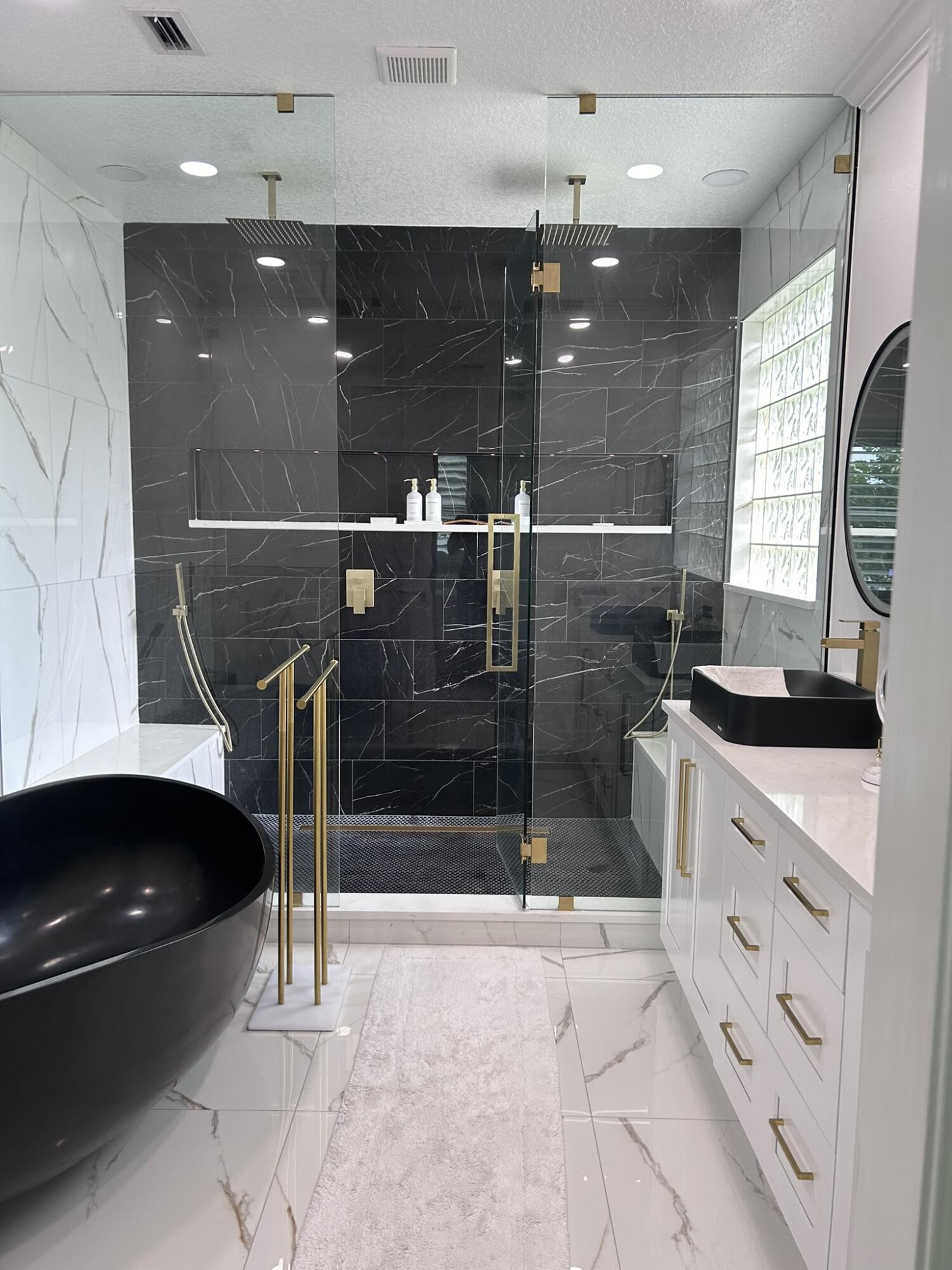 3158 Southwest Martin Street Port St. Lucie, FL 34953 - Photo 1 of 26 a bathroom with a sink a large mirror and shower